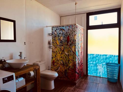 a bathroom with a shower and a sink and a toilet at Casa con vista a los volcanes y Lago Llanquihue in Puerto Varas