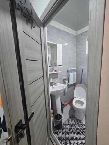 a bathroom with a toilet and a sink at Guest House in Talghar