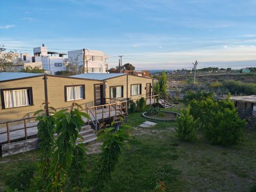 a house in the middle of a field at Las Cabañas in Las Grutas