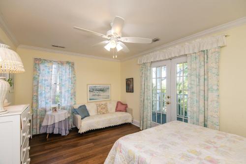 a bedroom with a bed and a ceiling fan at Marsa's Place in Edisto Island