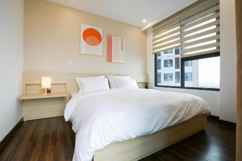 Ένα ή περισσότερα κρεβάτια σε δωμάτιο στο Sunmie Home Hoàng Huy Commerce Apartment