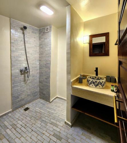a bathroom with a shower and a sink at Riad Dar Mazaj Fes in Fez
