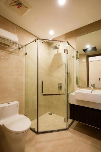 a bathroom with a shower and a toilet and a sink at Sunmie Home Hoàng Huy Commerce Apartment in Hai Phong