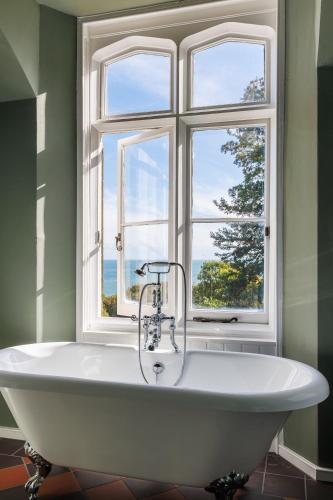 a bath tub in a bathroom with a window at East Dene Estate in Ventnor