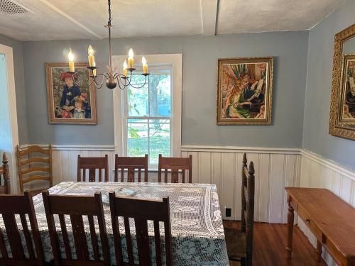 a dining room with a table and chairs and paintings at New Leeds listing Near Graces diner and Hudson! in Catskill