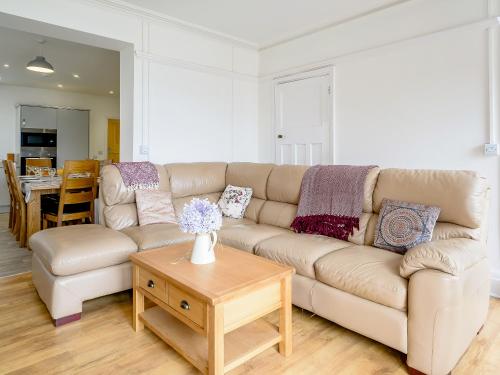 ein Wohnzimmer mit Sofa und Tisch in der Unterkunft Beachside, West Yardley House - Uk31200 in Downderry