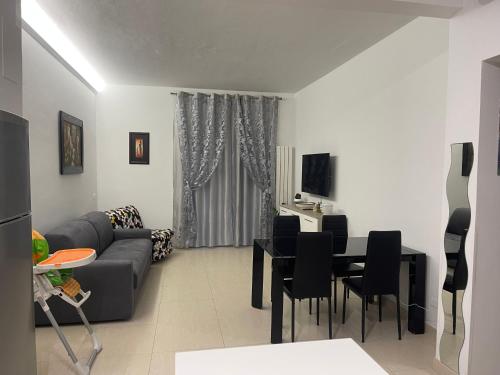 a living room with a couch and a table at Lora's House 5Terre in La Spezia