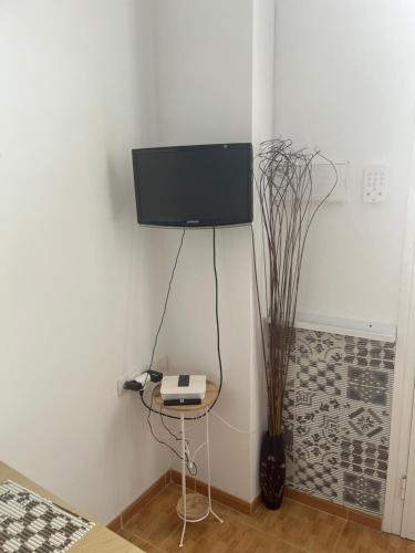 a room with a table with a tv on a wall at Studio La Caleta De Interian Garachico in Caleta de Interián