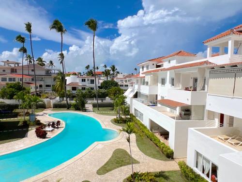an aerial view of a resort with a swimming pool and palm trees at Condo very close beach in Punta Cana