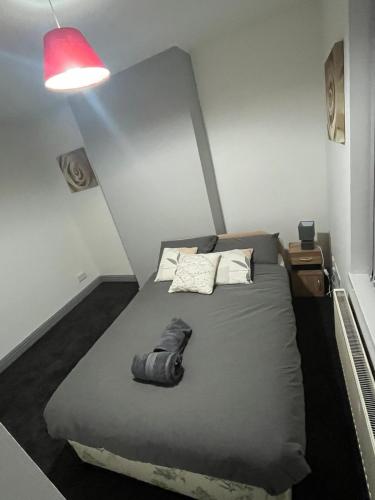 a bed in a small room with a red light at Heath lodge in Newcastle under Lyme