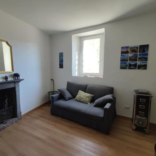 a living room with a couch and a fireplace at Charme nel borgo - Appartamento Lina in Corniglio