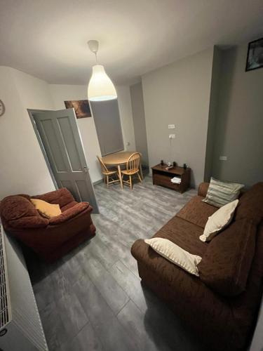 a bedroom with a bed and a couch and a table at Heath lodge in Newcastle under Lyme