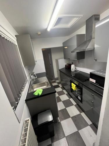 a kitchen with a sink and a counter top at Heath lodge in Newcastle under Lyme