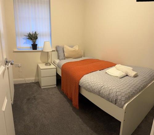 a small bedroom with two beds and a window at Home 4 Home short stay in Warren