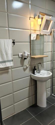 a bathroom with a sink and a mirror at Asmaaltı GUEST HOUSE in Bursa