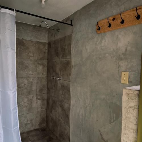 a shower with a shower curtain in a bathroom at Xelva Hostel & Travel community in San Cristóbal de Las Casas