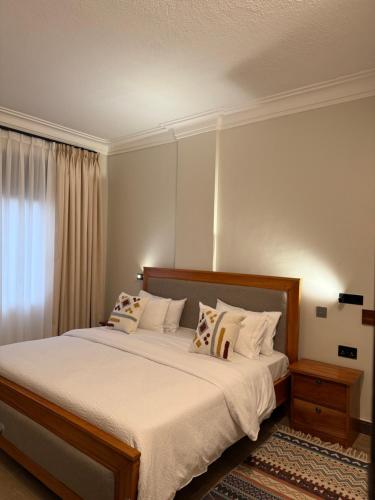 Ένα ή περισσότερα κρεβάτια σε δωμάτιο στο Rutuha Home Kyanja 2