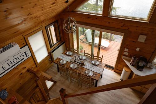 an overhead view of a dining room and kitchen in a log cabin at Red Cedar Haven Lakeside Tranquility in Sidney