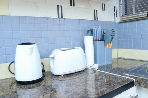 a white toaster sitting on a counter in a kitchen at The Rest in Maseru