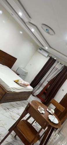 a bedroom with two bunk beds and a table at Keur Mame Coumba in Saint-Louis