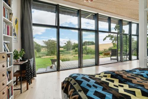 a bedroom with a bed and a large window at Sea View, Sunrise And 200 Meters To The Water in Kalundborg