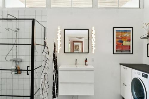 a bathroom with a sink and a washing machine at Sea View, Sunrise And 200 Meters To The Water in Kalundborg