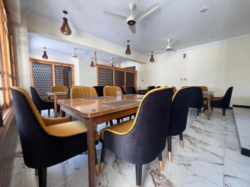 a conference room with a wooden table and chairs at Nawab's Hotel Balakot in Bālākot