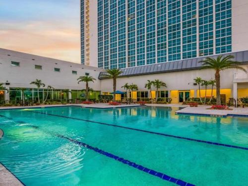 a large swimming pool in front of a building at Oasis Downtown Fort Myers, Pool, Parking ,Pet Friendly in Fort Myers