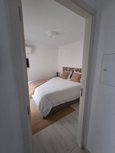 a bedroom with a bed and a large doorway at 2SEA - Apartamento na praia do Ouro - Sesimbra in Sesimbra