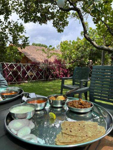 a tray of food on a table with food on it at Chaloba Hills Agro Resort in Ajra