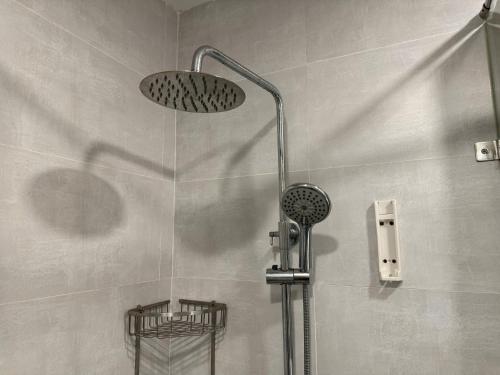 a shower with a shower head in a bathroom at Elite Apartment - Resort Pool & Gym by Center HCMC in Ho Chi Minh City