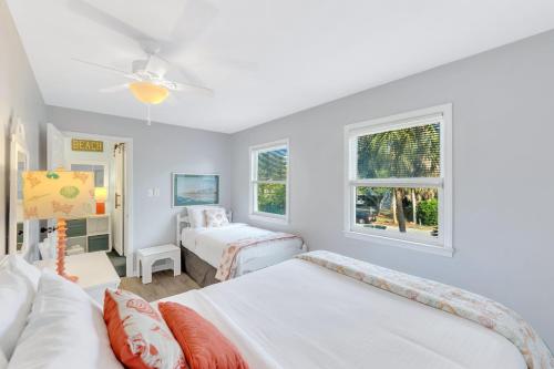 a bedroom with two beds and two windows at CM4005: 4005 Cameron Blvd. in Isle of Palms