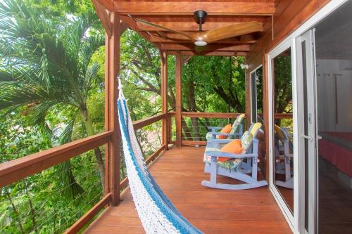 een veranda met een hangmat in een huis bij West Bay Unique Home with an amazing oceanview in West Bay