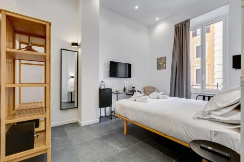 a bedroom with a large bed and a desk at Relais San Giovanni in Rome