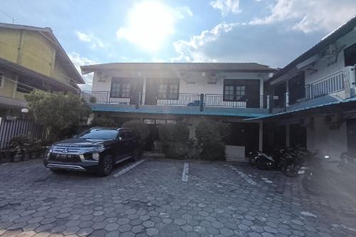 a truck parked in a parking lot in front of a building at JJ House Kost Exclusive Nologaten in Yogyakarta