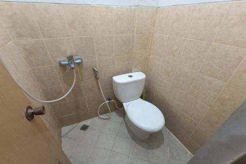 a bathroom with a toilet and a shower at JJ House Kost Exclusive Nologaten in Yogyakarta