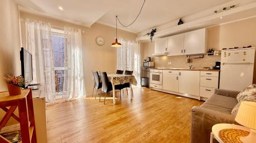 a kitchen and living room with a table and chairs at Casa Kiara by KALMA in Domodossola