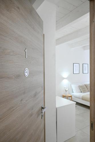 a door leading into a room with a bed at DoMe Affittacamere in Iglesias
