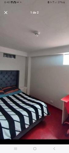 Ένα ή περισσότερα κρεβάτια σε δωμάτιο στο Hostal Qori