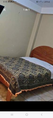 Ένα ή περισσότερα κρεβάτια σε δωμάτιο στο Hostal Qori