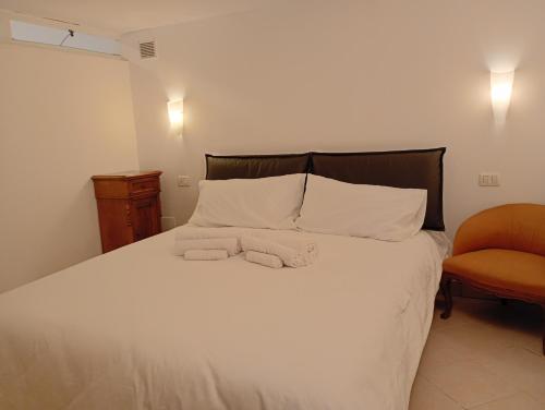 a bedroom with a bed with two towels on it at La Casetta in Ancona