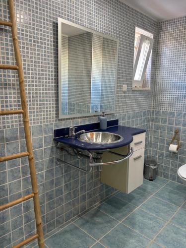 a bathroom with a sink and a mirror at Ria Seahouse Cabanas de Tavira in Tavira