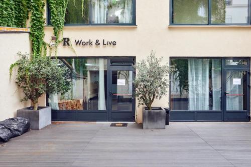 a building with a sign that reads r work and live at Loods - RDC G in Paris