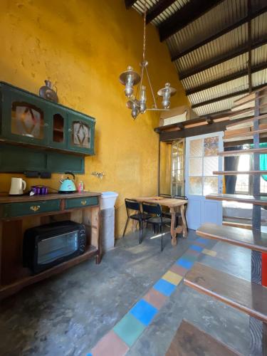 a living room with a table and a dining room at El Granero Apart hotel in Mar del Plata
