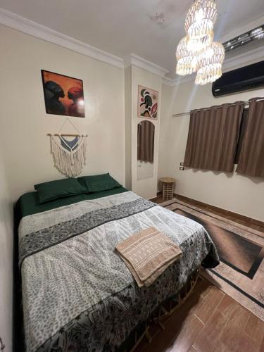 a bedroom with a bed and a chandelier at Aswan House center in Aswan