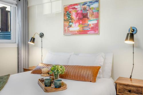 a bedroom with a bed with a tray with plants on it at Near Downtown & Waterfront, AC, Pet Friendly in Tacoma