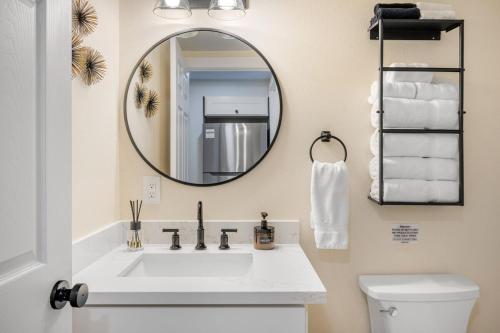 a bathroom with a white sink and a mirror at Near Downtown & Waterfront, AC, Pet Friendly in Tacoma