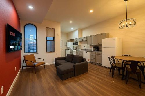 a living room with a couch and a table at Soulard King Loft near Anheuser-Busch Brewery in Soulard