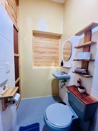 a bathroom with a blue toilet and a sink at Costa Rentals Palmar & Wasi in Brisas de Zicatela