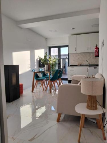 a kitchen and living room with a table and chairs at Costa Home in Gafanha da Nazaré